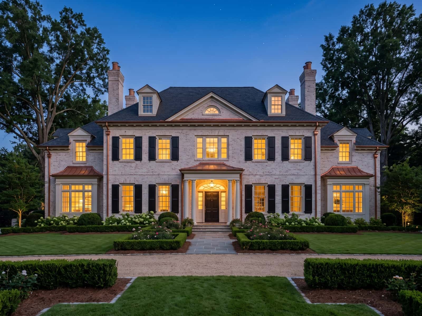 Limewashed Georgian revival beneath mature oaks